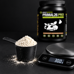 Scoop and serving scale 30g serving of Primal26 PRO whey protein isolate powder on a digital kitchen scale with a measuring scoop